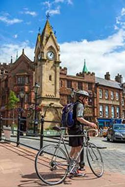 Cyclist at the Musgrave Monument photo courtesy of John Burrows Photography