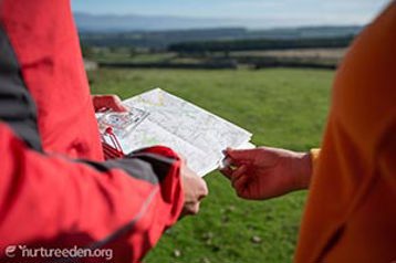 Walkers with map photo by Tony west courtesy of the Nurture Eden Photo Library