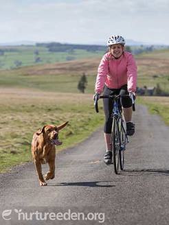 Cyclist and dog photo by Tony West, courtesy of the Nurture Eden photo Library