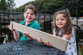 Pooley Bridge residents Raphael (8) and Sibella (4) Barbosa try out a paver for size