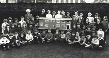 Miss Shaul, (back row, far left), pupils, and their matchstick model of the school building. c.1965