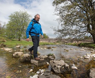 Walker crossing river photo courtesy of the Nurture Eden photo library