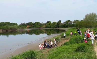 Children taking part in activities next to the River Eden