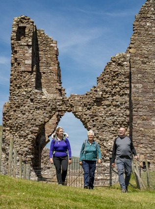 Walkers at Brough Castle photo courtesy of the Cumbria Photo Library