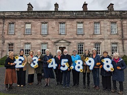 Members of the Hospice Team and Dalemain marmalade team and volunteers announcing total raised for Hospice at Home by Marmalade Awards