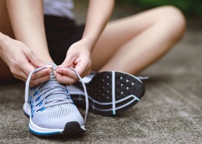 Runner lacing up trainers